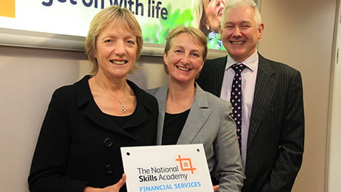 (L-R) Sylvia Perrins, chief executive of the National Skills Academy for Financial Services, presents a plaque marking the Service Excellence accreditation to Leeds Building Society Operations Director Karen Wint and Chief Executive Peter Hill.